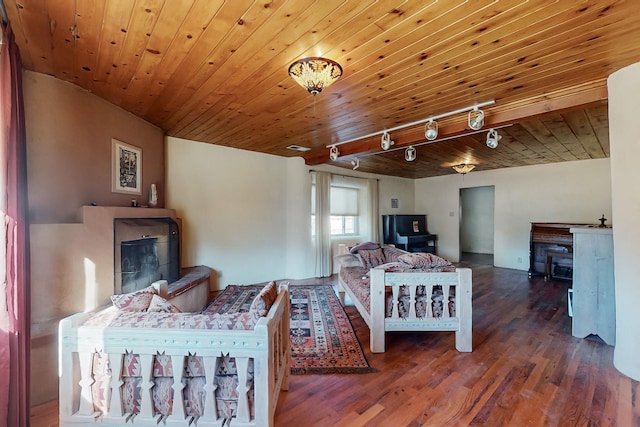 living room featuring dark wood-type flooring, track lighting, and wood ceiling