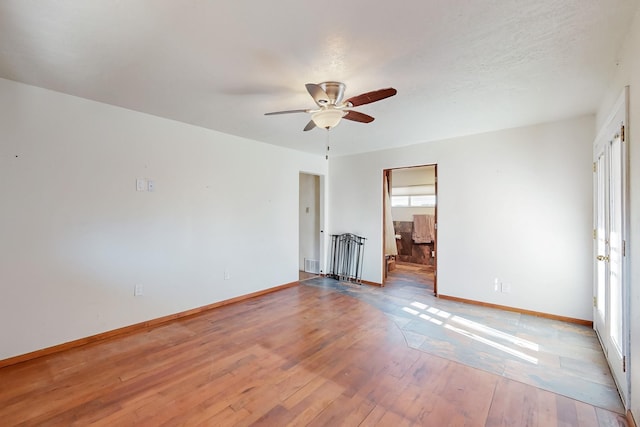 unfurnished room with ceiling fan and light wood-type flooring