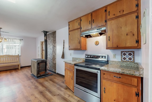 kitchen featuring light stone countertops, stainless steel range with electric cooktop, and light wood-type flooring