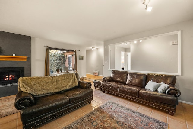 living room featuring a large fireplace and light tile patterned floors