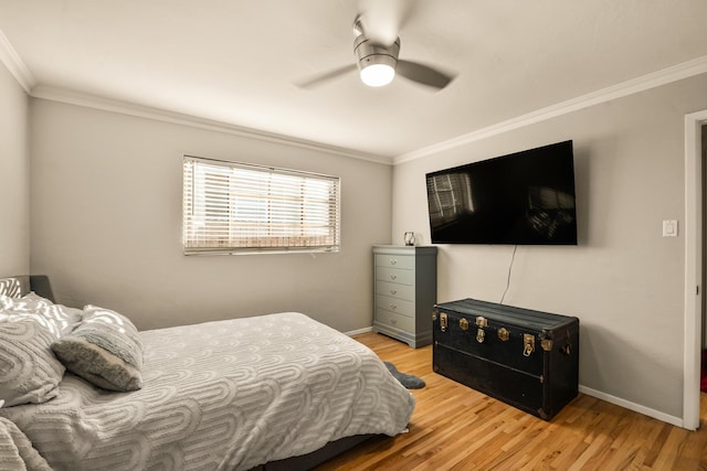 bedroom with ornamental molding, a ceiling fan, baseboards, and wood finished floors