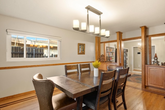 dining room with light wood-style flooring and baseboards