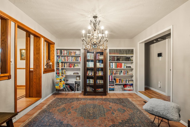 living area with light tile patterned flooring and an inviting chandelier