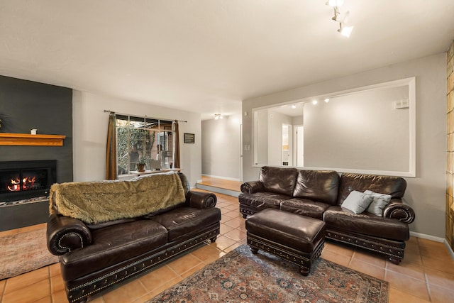 living room featuring light tile patterned floors and a fireplace