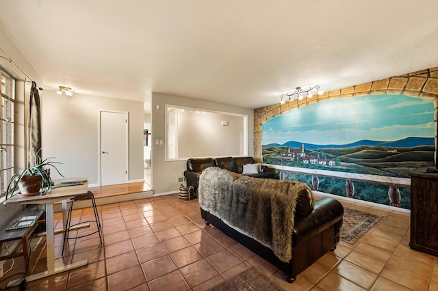 living area featuring baseboards and tile patterned floors