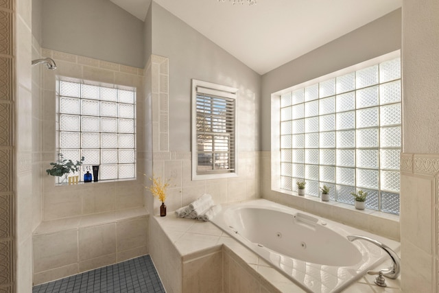 bathroom featuring tile patterned flooring, vaulted ceiling, and plus walk in shower