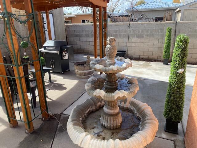 view of patio / terrace with a grill and fence