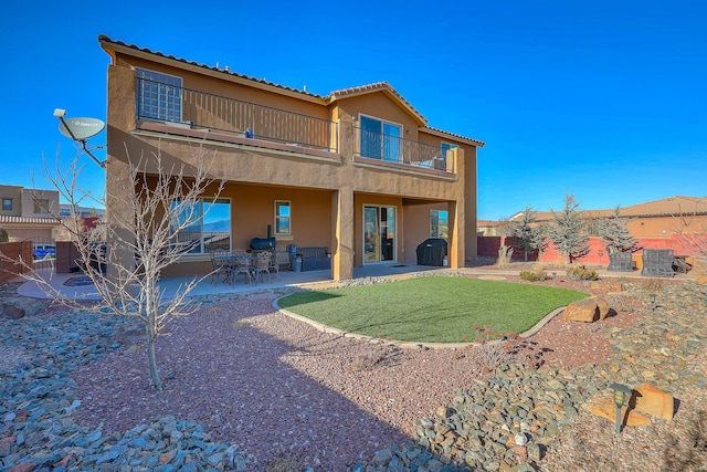 back of property featuring a patio area and a balcony