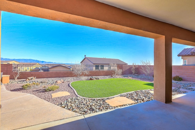 view of yard with a mountain view and a patio