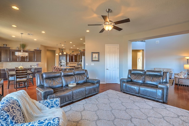 living room with dark hardwood / wood-style floors and ceiling fan