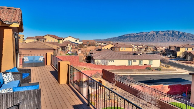 wooden deck featuring an outdoor living space and a mountain view