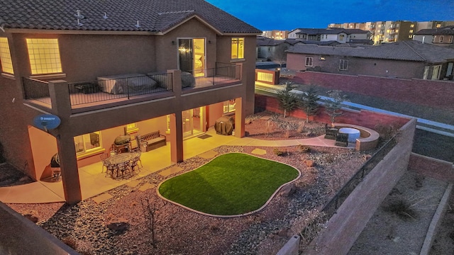 view of yard featuring a balcony, exterior kitchen, and a patio area