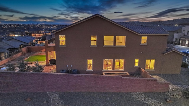 view of back house at dusk