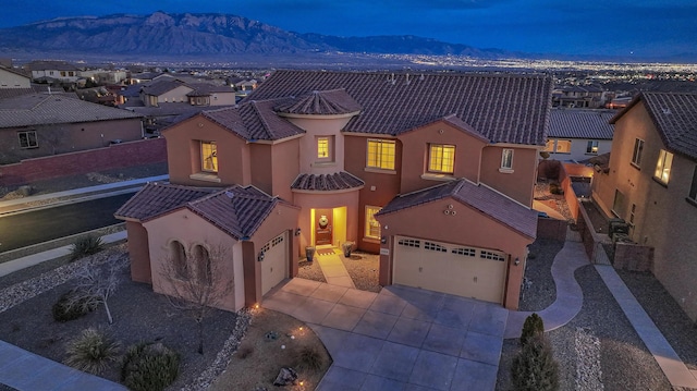 view of front of house featuring a garage and a mountain view