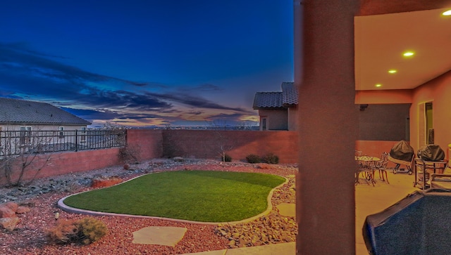 yard at dusk with a patio