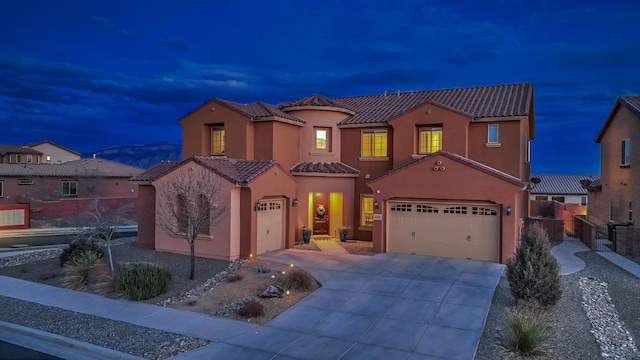 mediterranean / spanish-style house with a garage