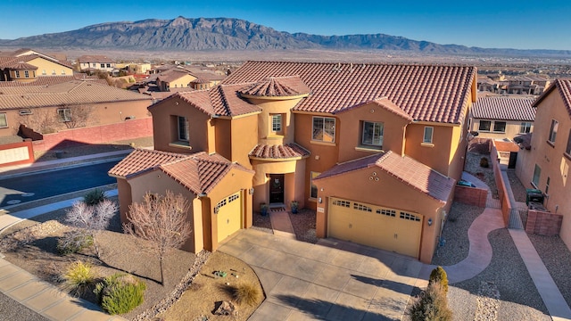 view of front of house featuring a garage and a mountain view