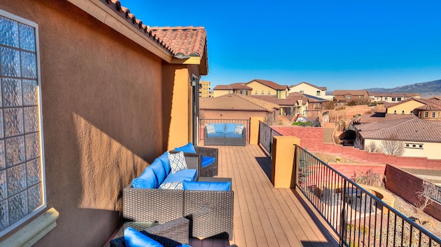 wooden terrace featuring a mountain view and outdoor lounge area