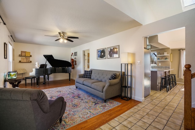 living room with ceiling fan and light hardwood / wood-style floors