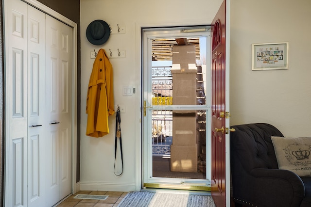 entryway with a healthy amount of sunlight and light tile patterned flooring