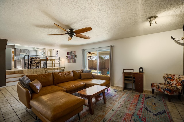 tiled living room featuring a textured ceiling and ceiling fan