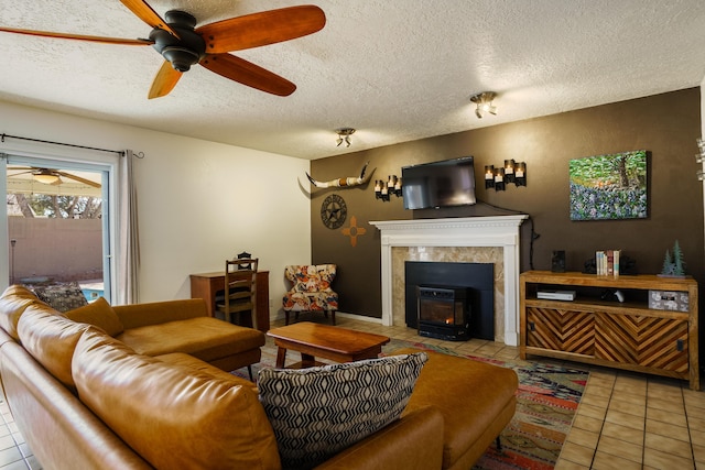 tiled living room with ceiling fan and a textured ceiling