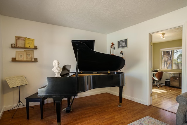 misc room with hardwood / wood-style floors and a textured ceiling