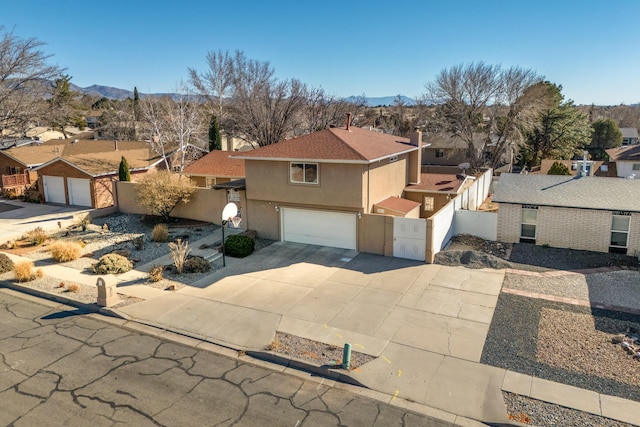 view of front of house featuring a garage and a mountain view