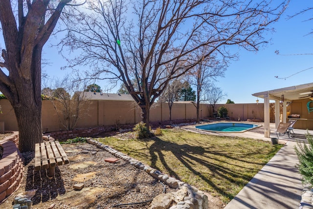 view of yard with a fenced in pool and a patio