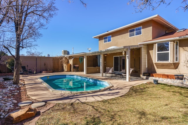 back of property with a fenced in pool, a patio area, and central air condition unit