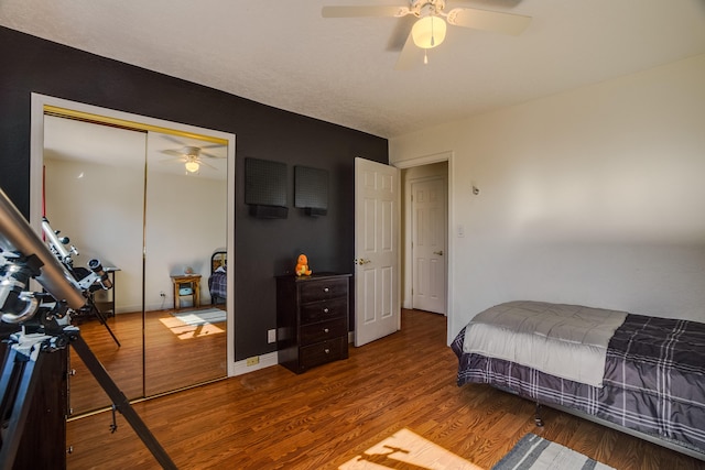 bedroom with hardwood / wood-style floors, ceiling fan, and a closet