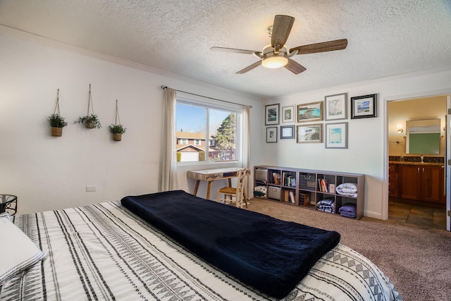 bedroom featuring crown molding, carpet flooring, ensuite bathroom, and a textured ceiling