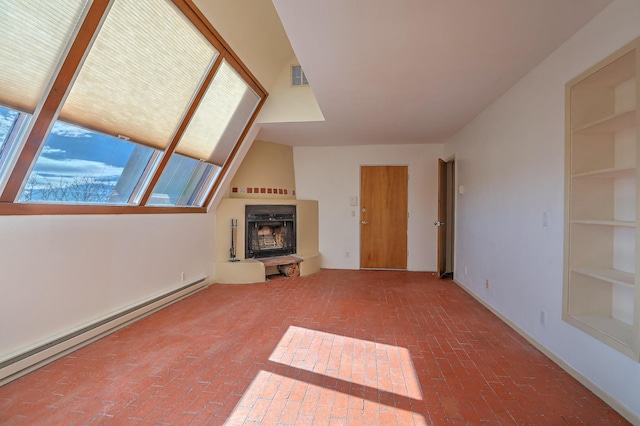 unfurnished living room with a fireplace and baseboard heating