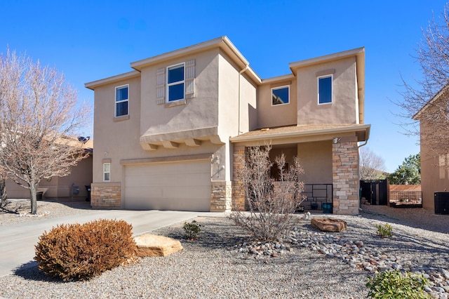 view of front facade with an attached garage, stone siding, concrete driveway, and stucco siding