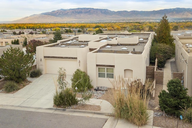 view of front of home featuring a mountain view and a garage