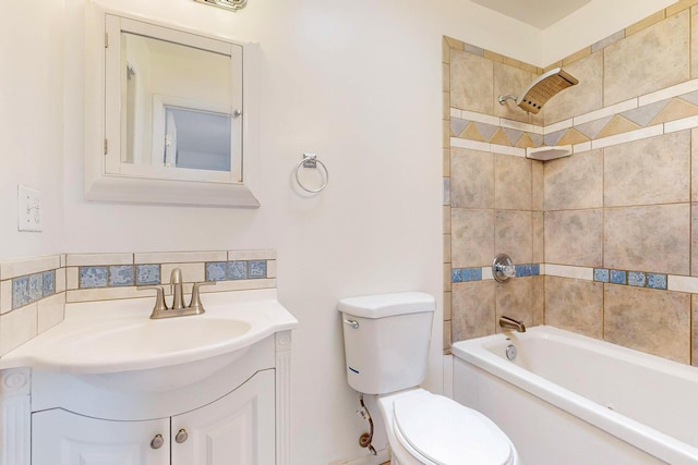 full bathroom with tiled shower / bath, vanity, decorative backsplash, and toilet