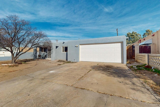 pueblo-style house featuring a garage