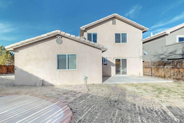 rear view of property featuring a patio area