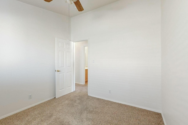 carpeted empty room featuring ceiling fan