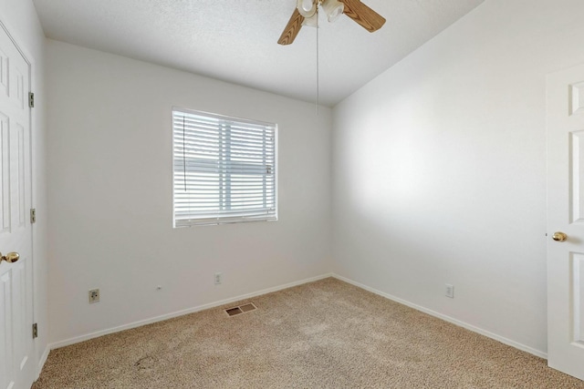 carpeted spare room featuring vaulted ceiling and ceiling fan