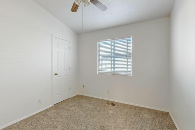 spare room featuring carpet floors and ceiling fan