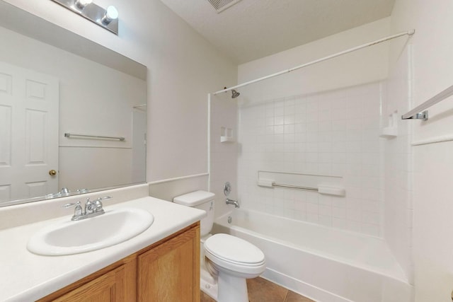 full bathroom featuring vanity, tiled shower / bath combo, tile patterned floors, and toilet