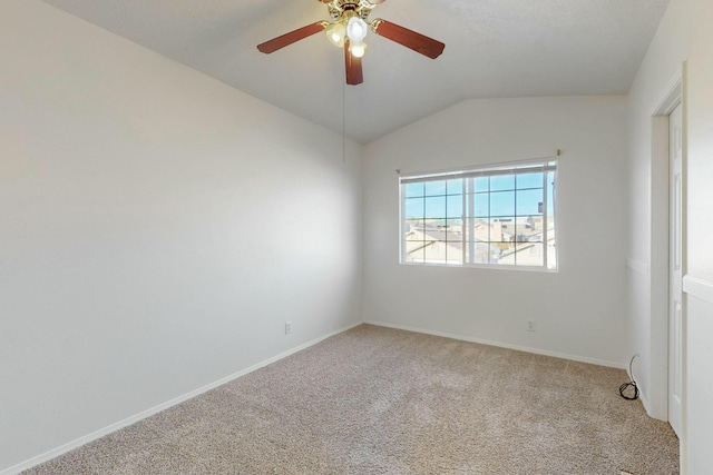 carpeted spare room with ceiling fan and lofted ceiling