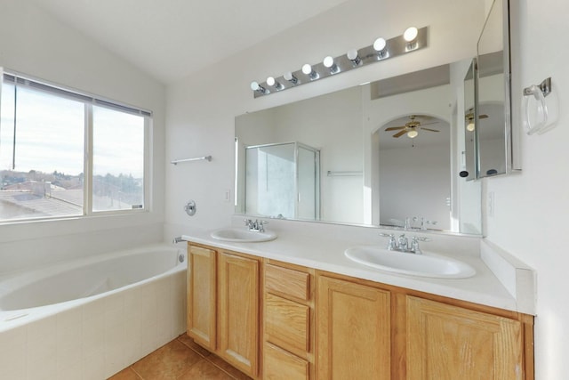 bathroom with independent shower and bath, lofted ceiling, tile patterned flooring, vanity, and ceiling fan