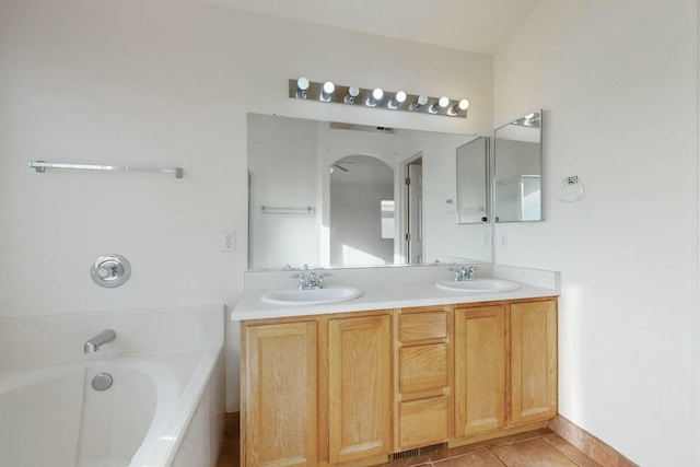 bathroom featuring vanity, a bathtub, and tile patterned floors