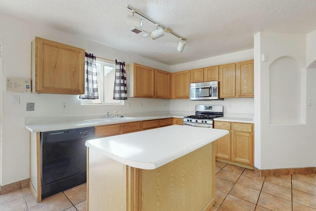 kitchen featuring sink, a center island, a textured ceiling, light tile patterned floors, and stainless steel appliances