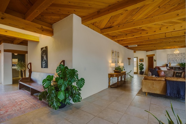 living room featuring wood ceiling, beamed ceiling, and light tile patterned flooring