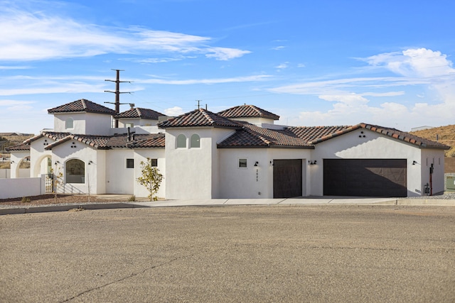 mediterranean / spanish home featuring a garage