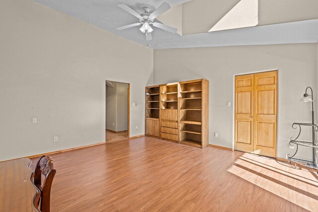 unfurnished living room with hardwood / wood-style flooring, ceiling fan, and vaulted ceiling