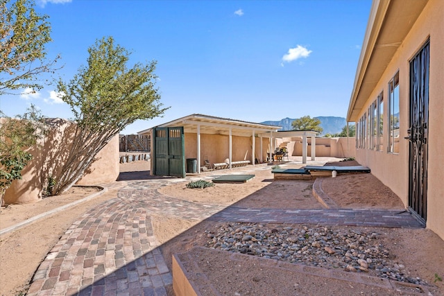 view of yard with a mountain view and a patio area